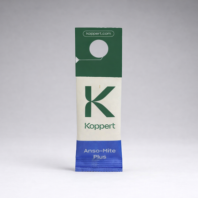 A rectangular sachet labeled Koppert and Amblyseius Andersoni Prevention Sachets features predatory mites for pest control. With a green, cream, and blue design, it hangs from a plant. The top flap displays koppert.com.