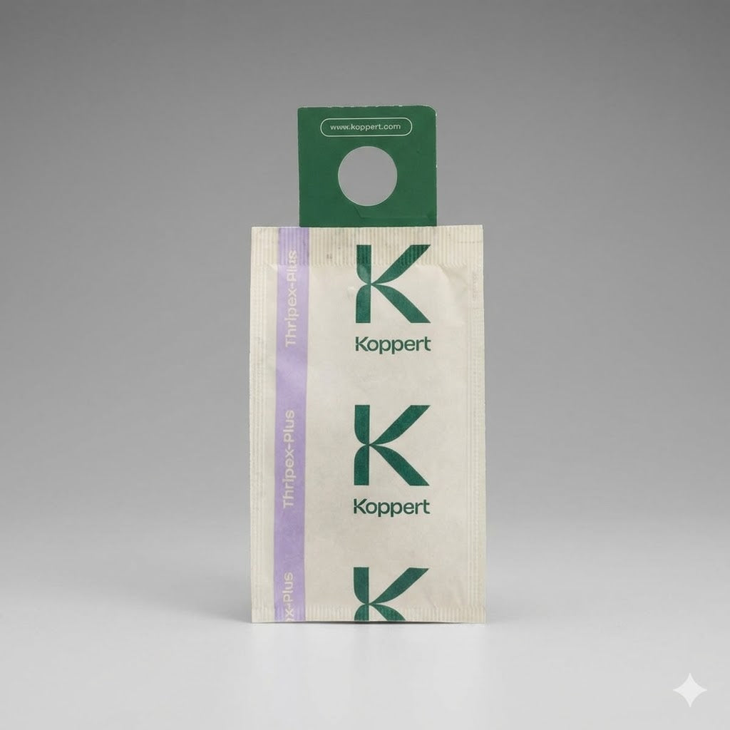 A Koppert Thripex-Plus sachet standing upright on a grey background: a cream paper sachet printed with a repeating green Koppert "K" logo, with a lilac vertical band down the left edge reading Thripex-Plus, topped by a green cardboard hanging tab with a round hole and www.koppert.com.
