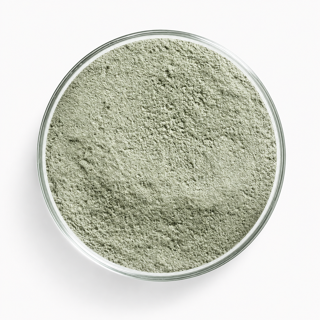 A glass dish of Trichoderma harzianum T-22 — a fine, pale green-grey powder.