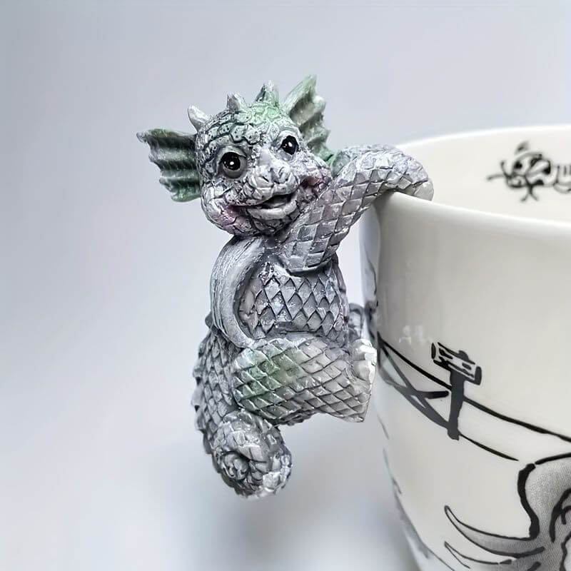 Mini dragon pot hanger adorably clinging to a planter, perfect for adding magical charm to indoor or outdoor spaces.