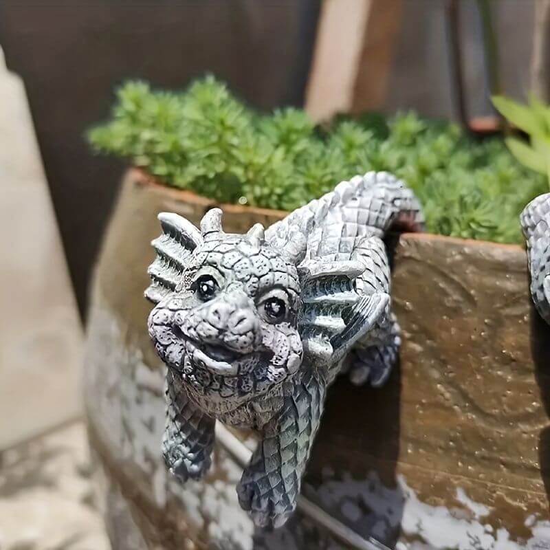 Charming mini dragon pot hanger on a planter with lush greenery, adding mythical charm to indoor or outdoor garden spaces.