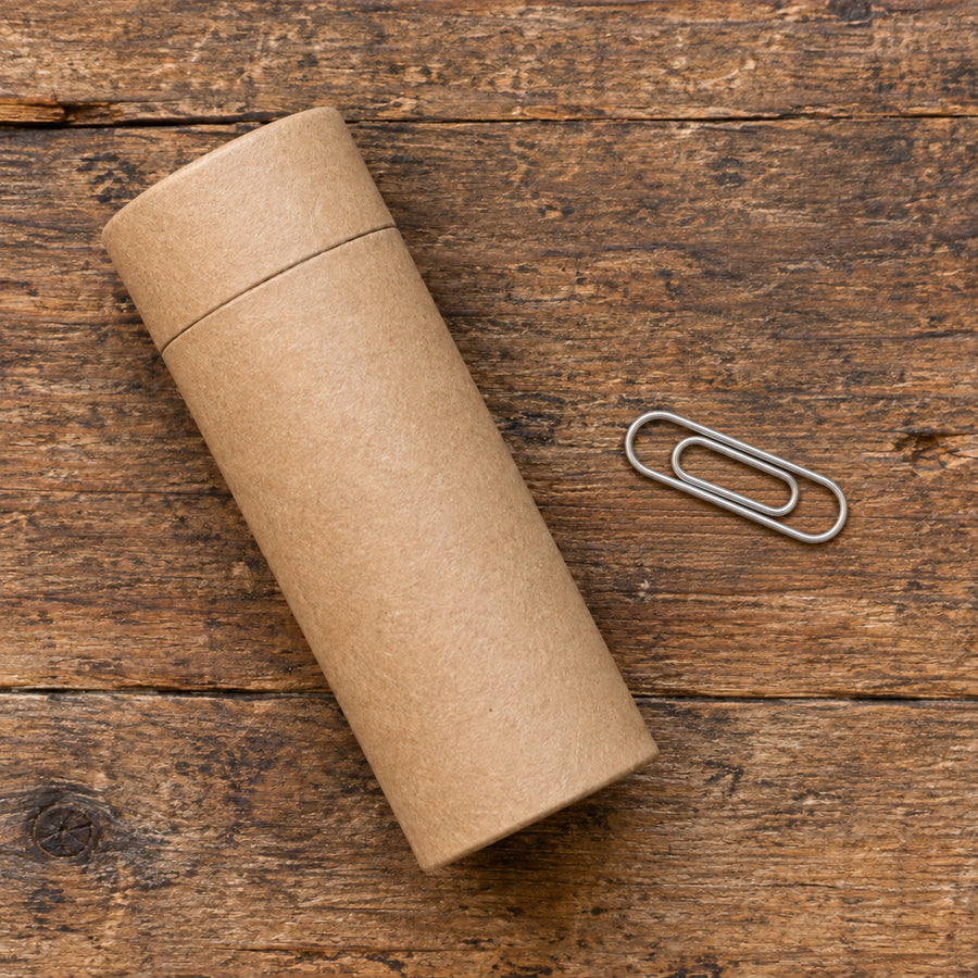 A release tube beside a paperclip for scale.